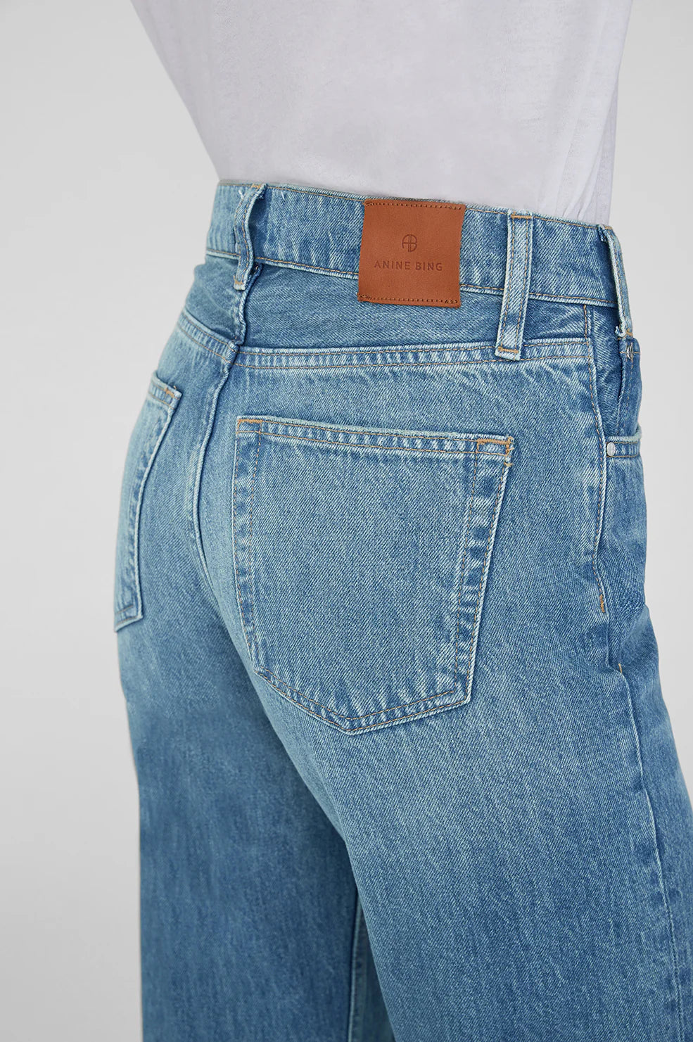 Blue jeans with a brand label on a white background