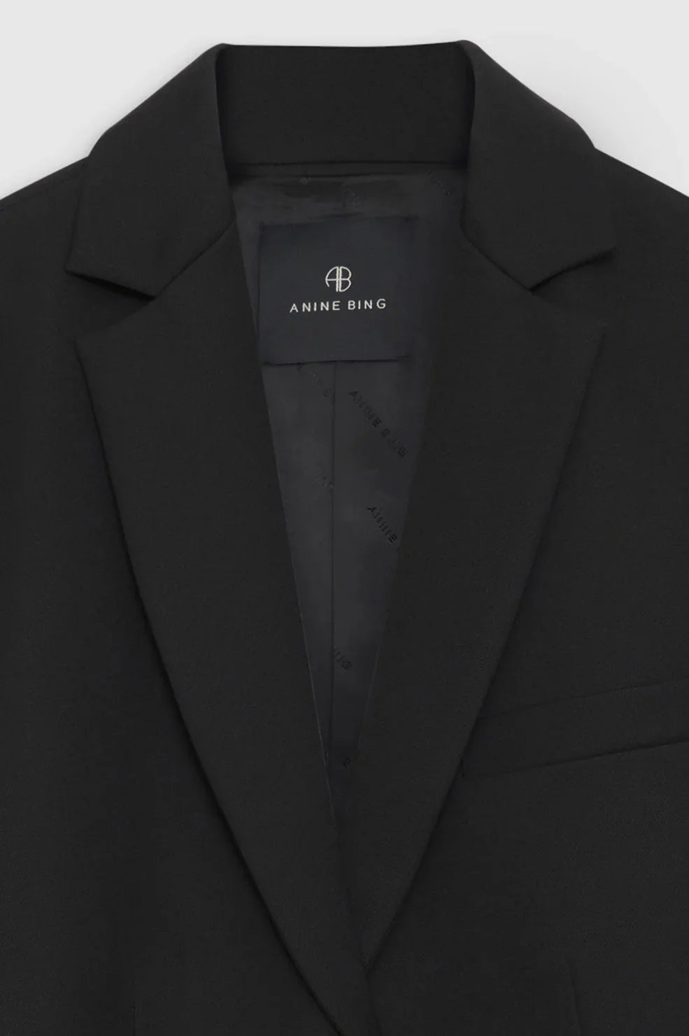 Quinn Black blazer with a visible brand label on a white background