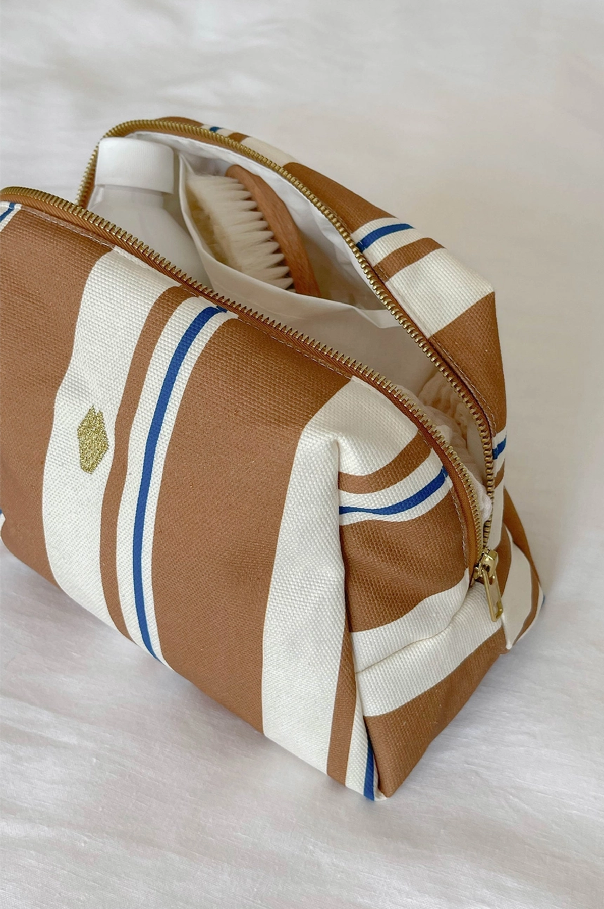 Brown and white striped bag with blue accents on a light background