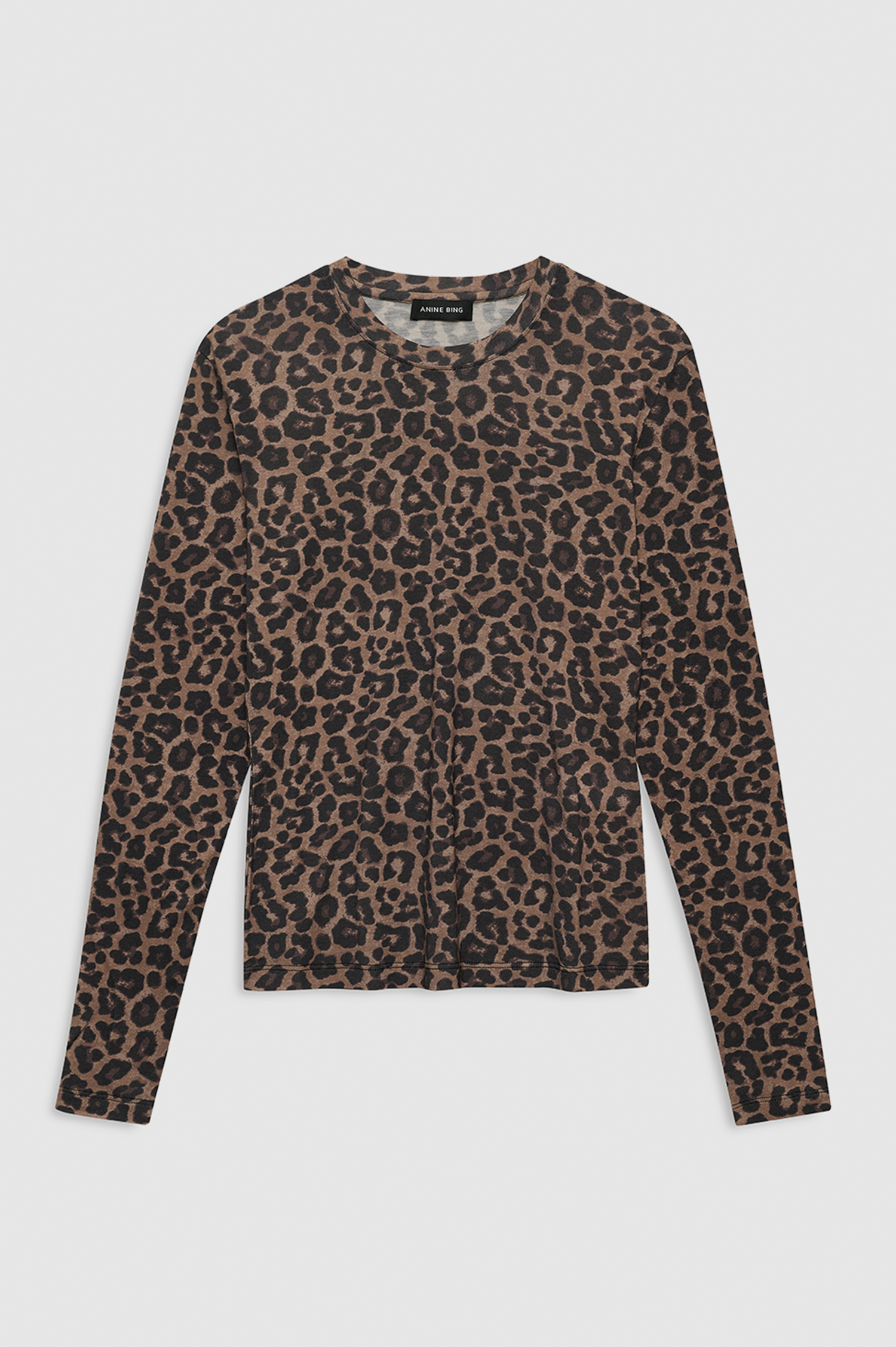 A long-sleeve crewneck top featuring an all-over leopard print pattern in brown, beige, and black, laid flat against a light gray background.