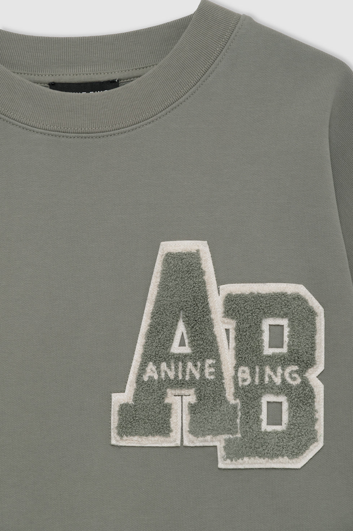 Green sweatshirt with 'AB' logo and text on a white background