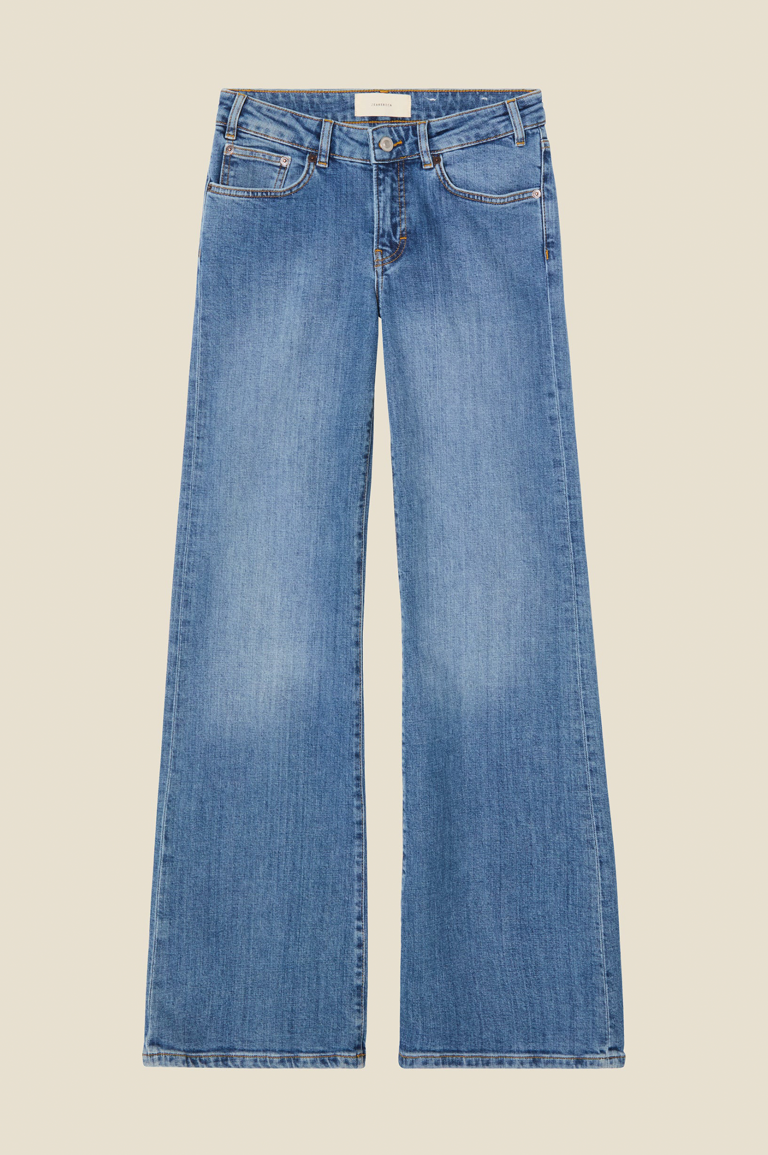 a pair och jeanerica san babila jeans on beige bckground