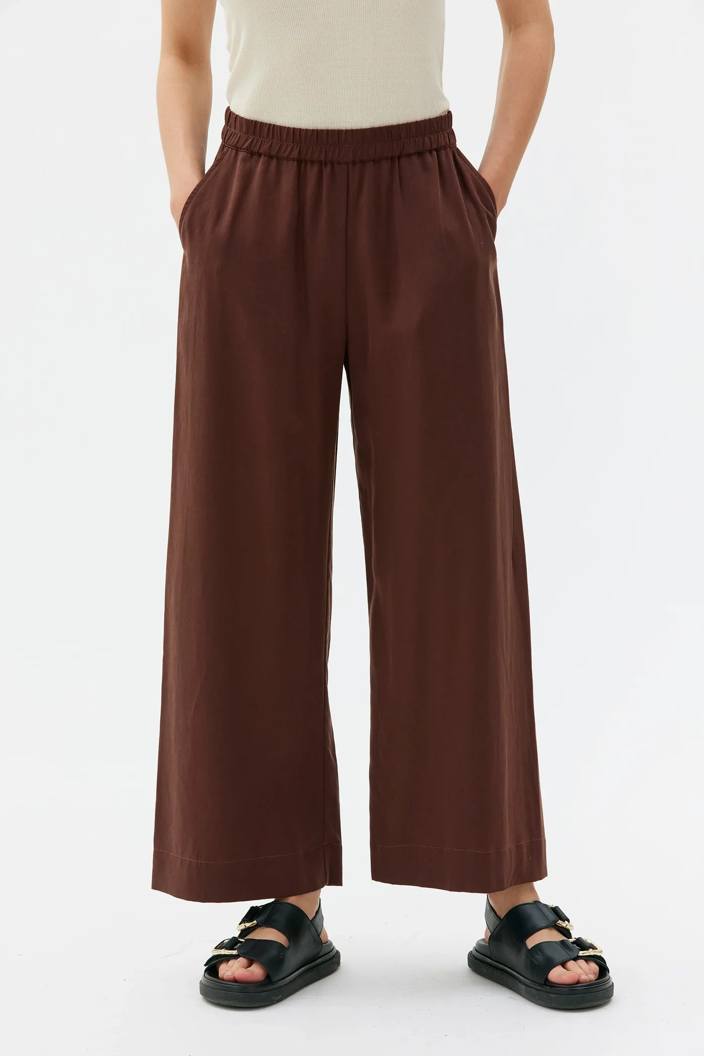 Brown wide-leg Thea pants from Maska worn by a person on a white background