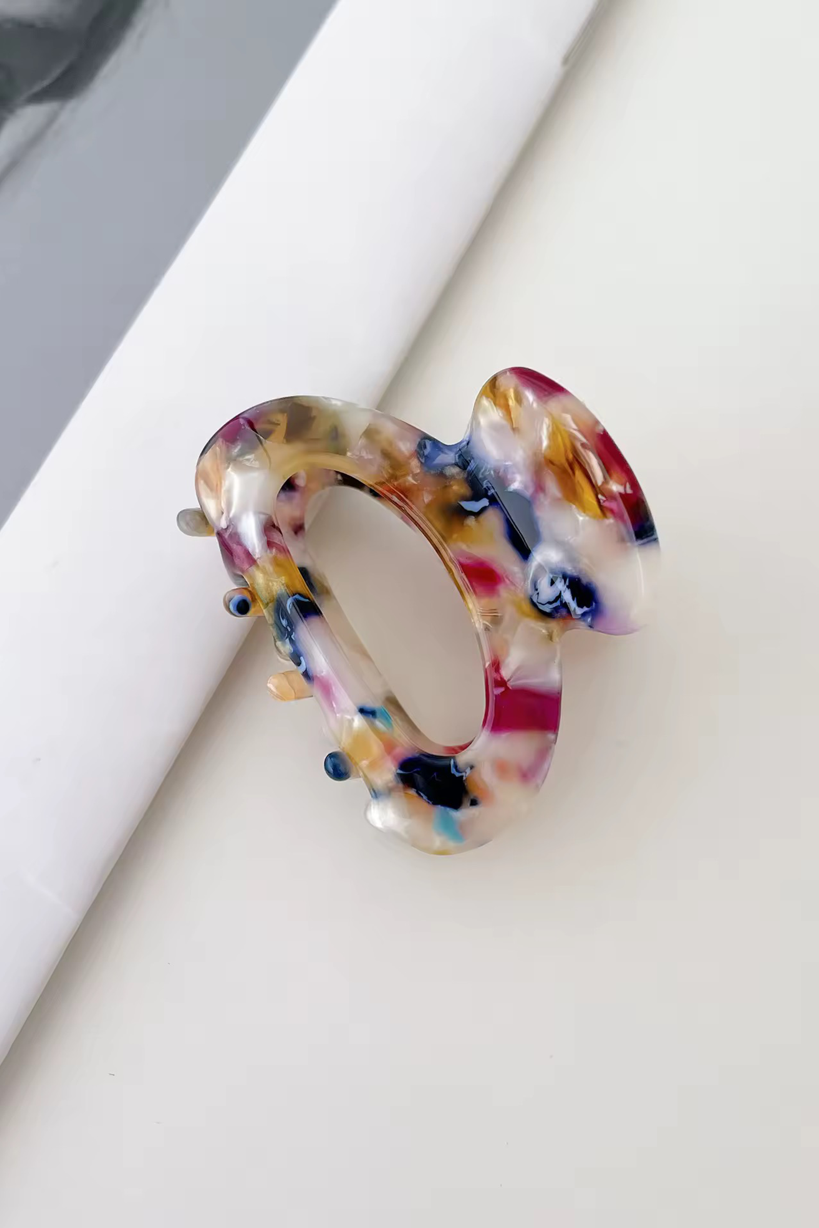 Multicolored hair clip on a white surface
