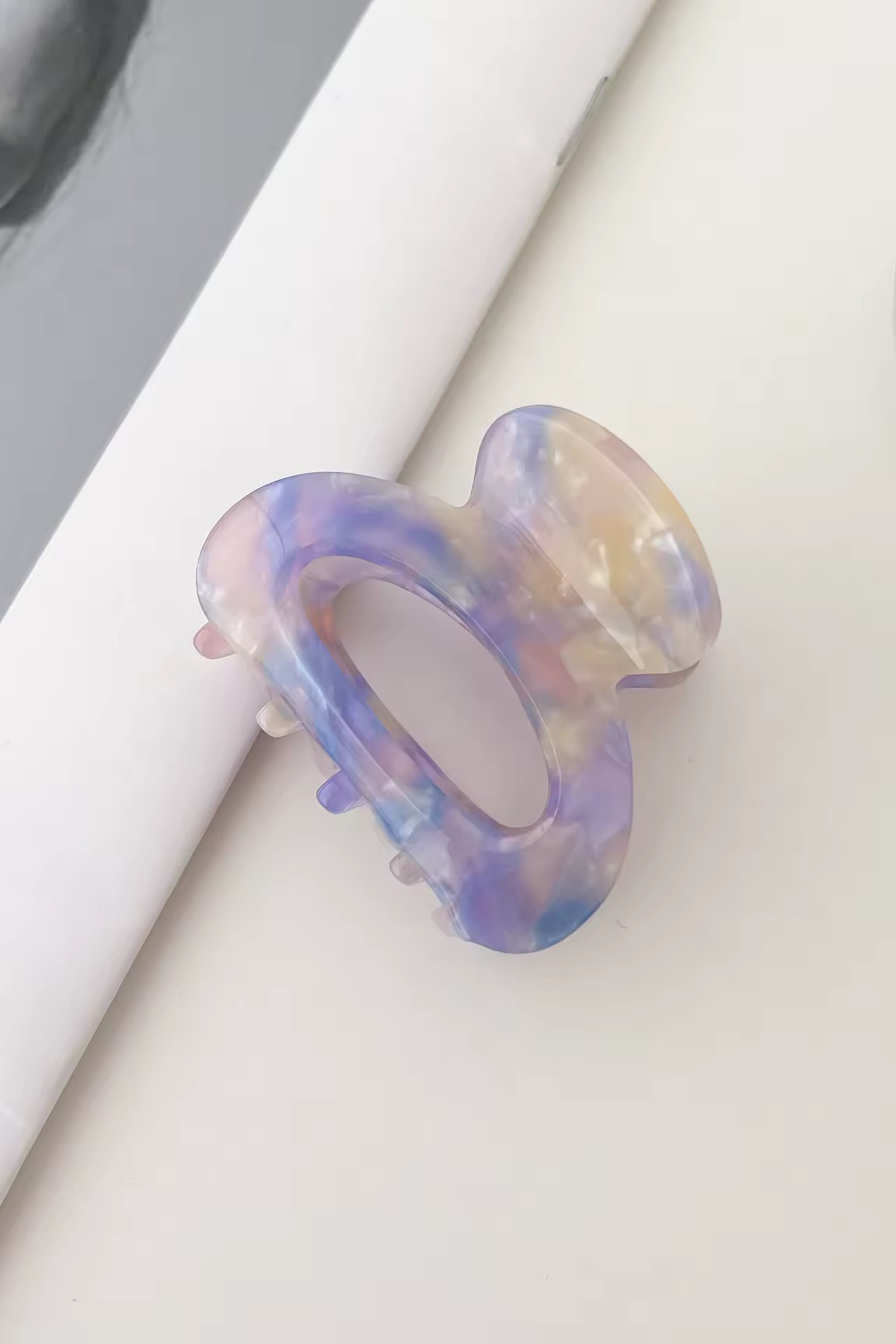 Multicolored hairclaw on a white surface