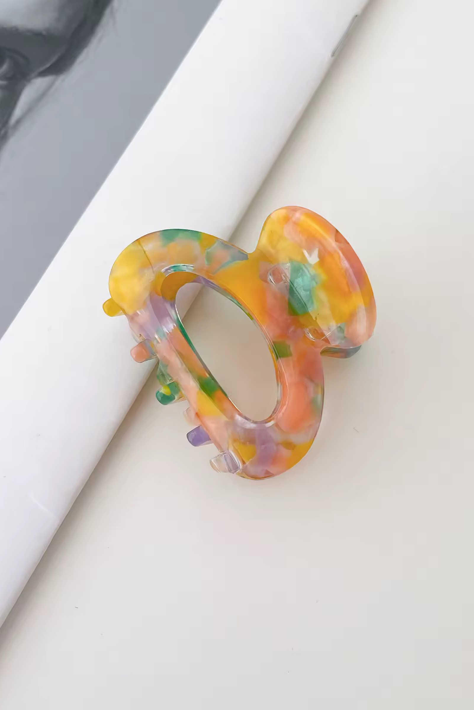 Colorful acrylic ring on a white surface