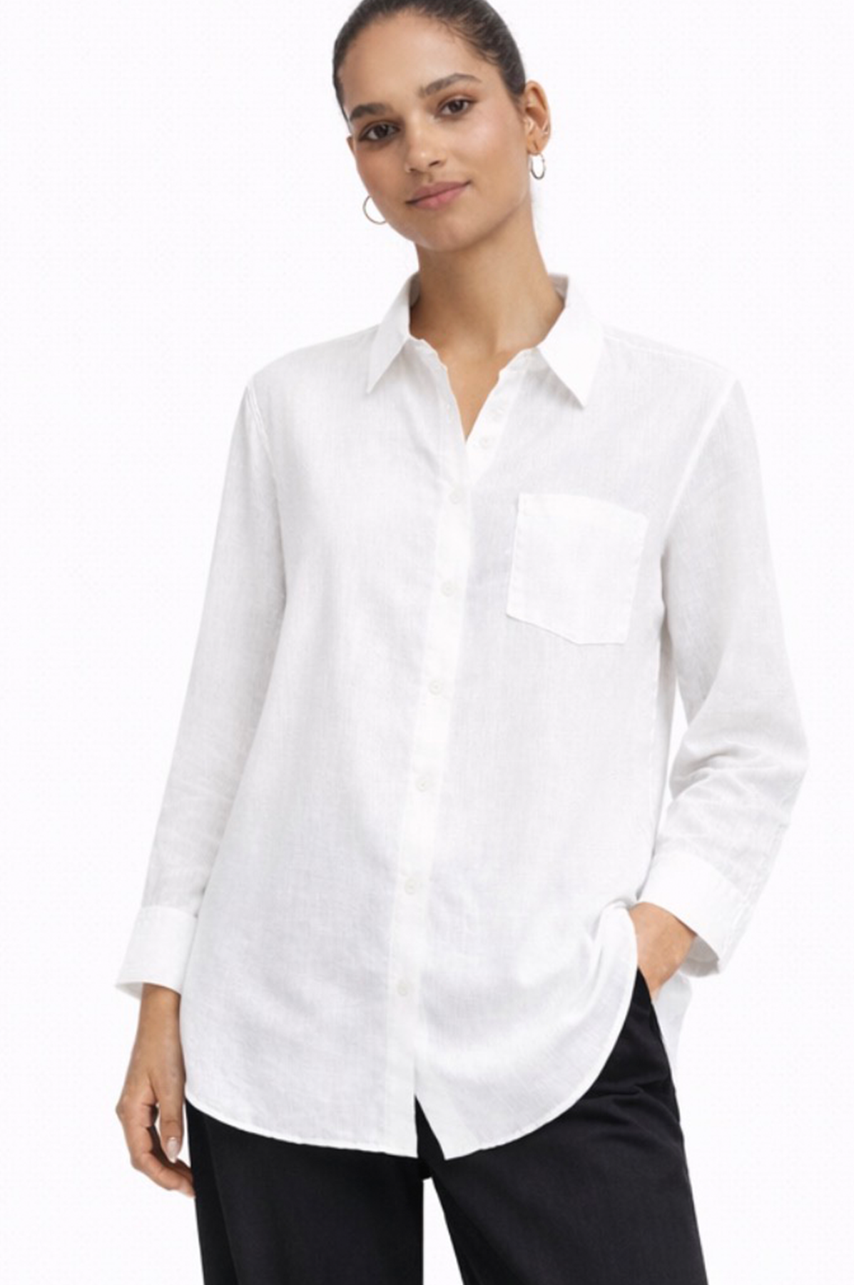Woman wearing a white button-up shirt on a white background