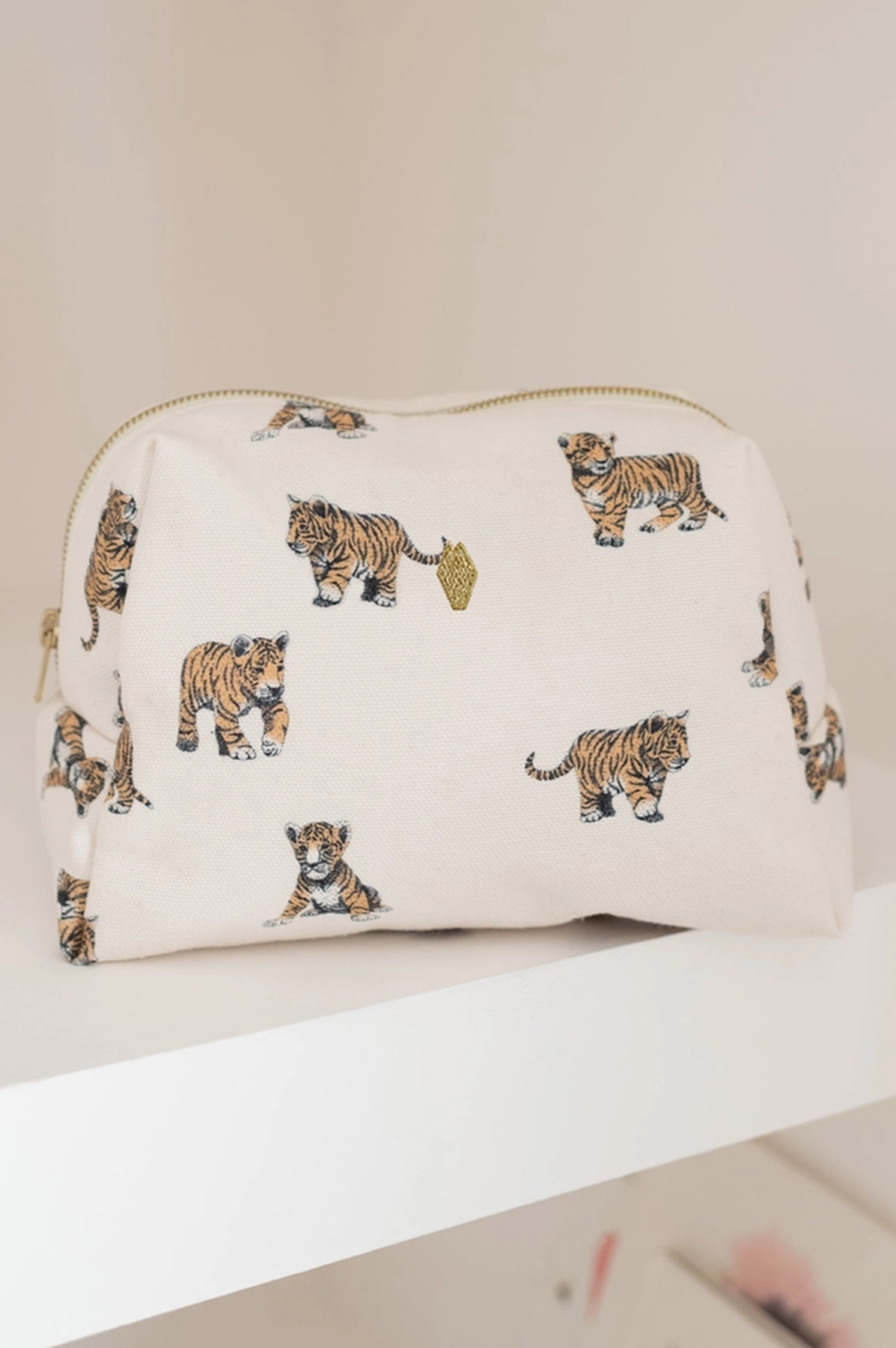 Cosmetic bag with tiger pattern on a white surface